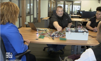 People working together around conference table in modern office setting during meeting or workshop